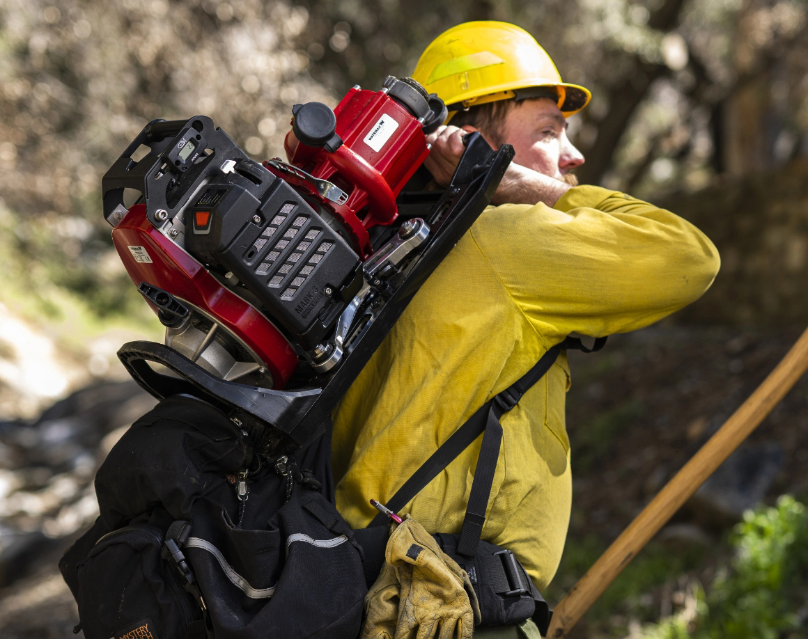 Firefighter with drip torch