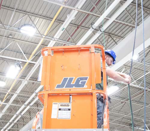 Installer-on-lift-wiring-fixture
