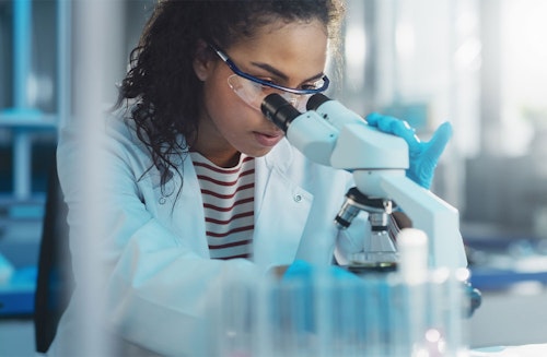 Woman Looking Into Microscope